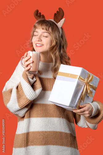 Pretty young woman holding ...