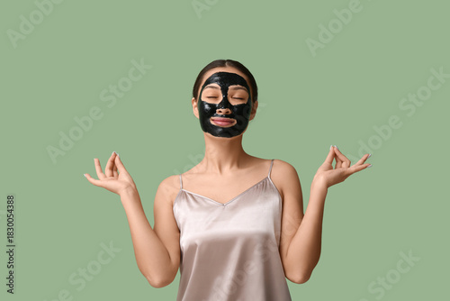 Meditating young woman with...