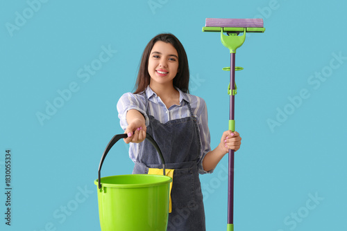 Young woman with floor mop ...