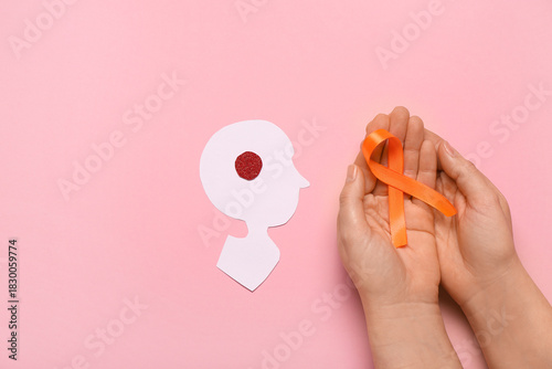 Female hands with orange ri...