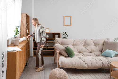 Young pretty woman cleaning...
