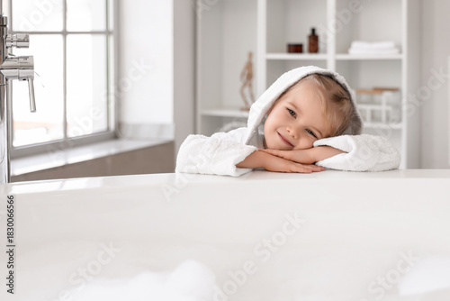 Cute little girl in bathrob...