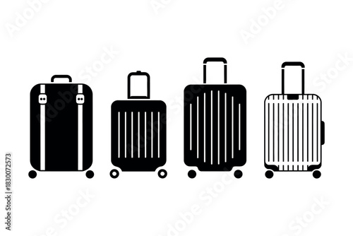 A line of four black and white suitcases with wheels and handles isolated