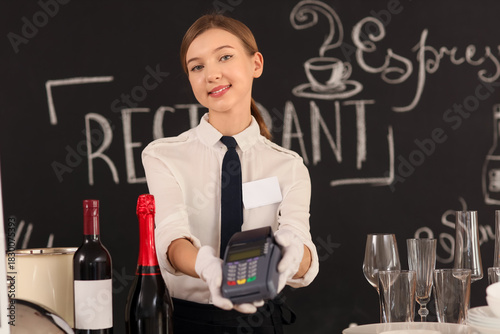 Young waitress with payment...