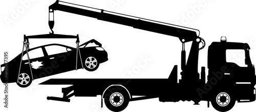 Silhouette of a tow truck lifting a broken down car with its crane
