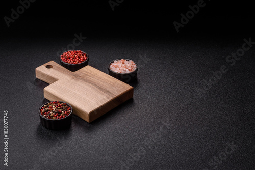 Wood, a wooden empty cutting board on a dark kitchen table. Wooden cutting board