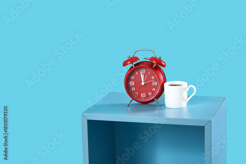 Alarm clock and cup of coff...