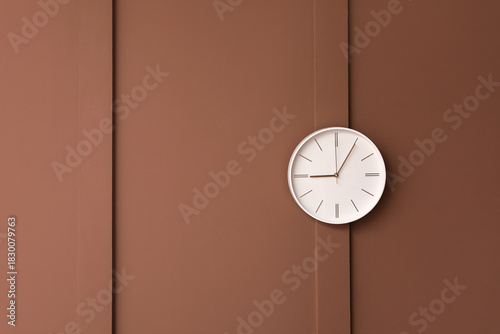 Stylish clock hanging on br...