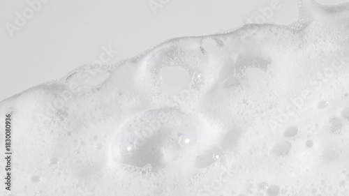 Bubbles of white soap foam. Moving Soap foam popping bubble on a white backdrop. Soap sud macro structure. Clean, cleaning concept, laundry, shower. . High quality 4k footage