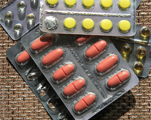 Pharmacy products. A lot of tablets on the fibrous surface. Colorful tablets in plastic blisters. Medicines in pharmaceutical packaging. Colorful tablets in plastic blisters. Medicine and health care
