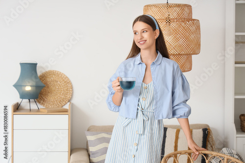 Smiling young woman holding...