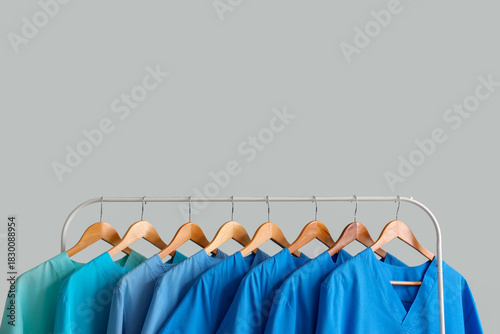 Canvastavla Rack with medical uniform on light background