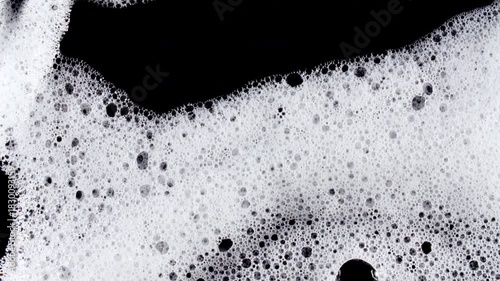 Texture of white soap foam with bubbles abstract background. Soap sud macro structure. Bathtup Soap Foam. Natural White Shampoo Bubbles Motion. High quality 4k footage