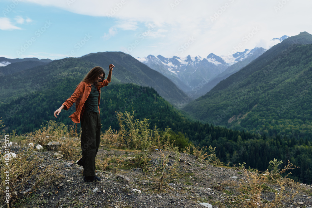 Naklejka premium Mountain hiker in nature on rugged landscape, person standing on ridge with solitude and wilderness around, journey and freedom captured in wide view, authenticity inclusivity