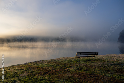 bench next to foggy lake