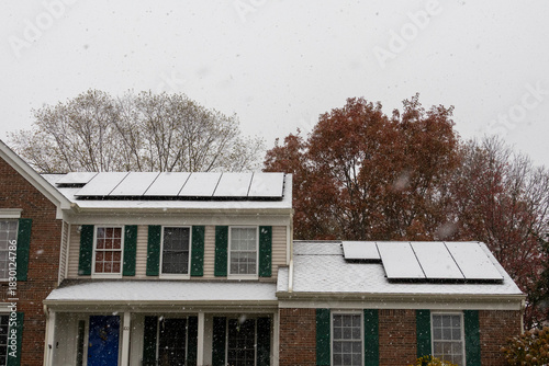 snowy solar panels on house