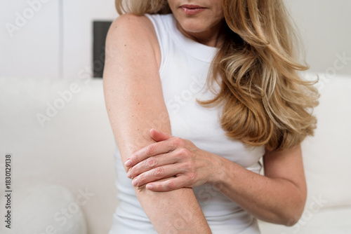 Woman with eczema experiences discomfort while managing skin condition at home