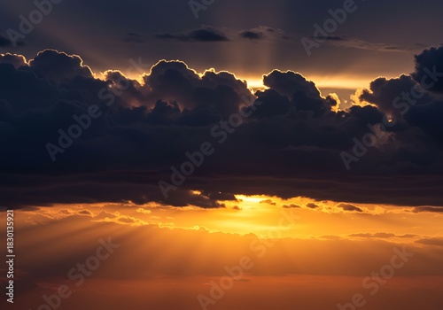 Dramatic sunset with radiant light beams breaking through dark clouds