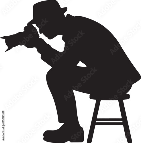 Silhouette of a man wearing a hat and jacket holding a camera and sitting on a stool person