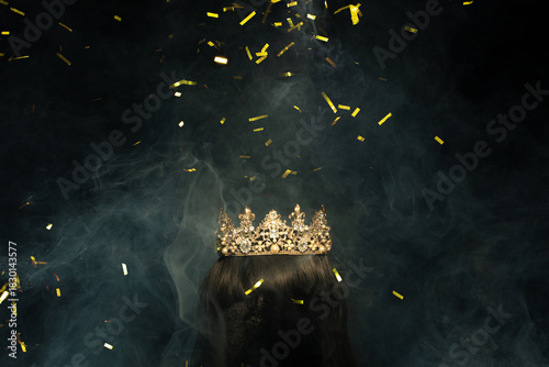 Gold Crown Diamond on hair wig model head. Sparking glitter diamond crown ready to put on winner wear head of Miss Beauty pageant contest. Black background isolated with smoke