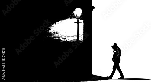 Mysterious hooded figure walks under a streetlamp at night casting a shadow on the building facade