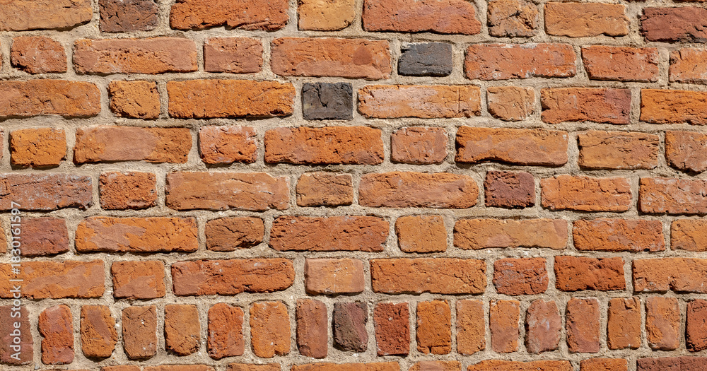 Obraz premium Old weathered red brick wall texture, rough masonry surface background, historic building facade detail. Construction material, orange clay bricks pattern, abstract backdrop, closeup, nobody