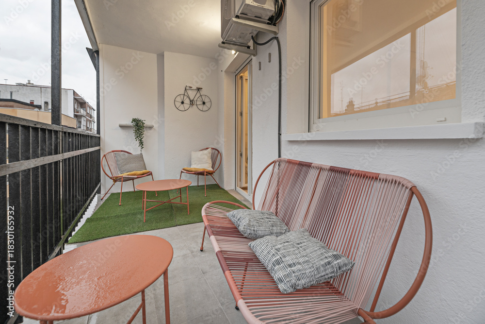 Obraz premium Urban garden terrace with artificial turf, herb planters, and an automated irrigation system