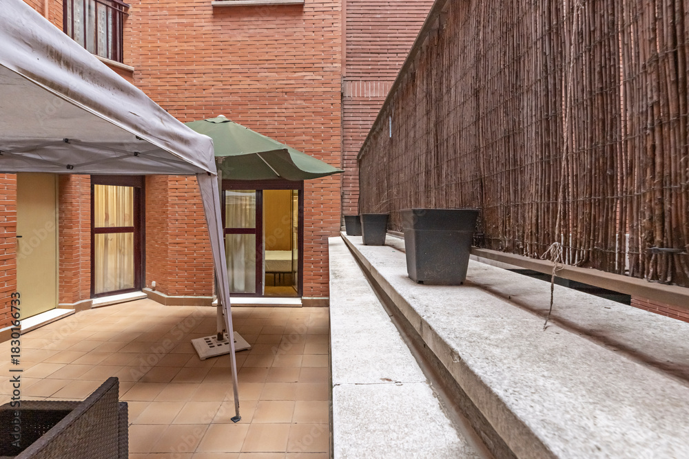 Obraz premium Residential rooftop terrace with gas barbecue, extendable dining table, and panoramic city skyline views