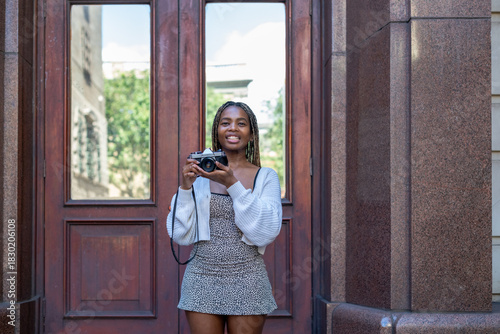 Young woman with vintage camera in hand