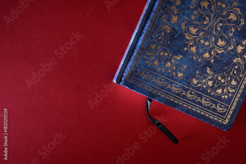 top view of the holy koran book on red background