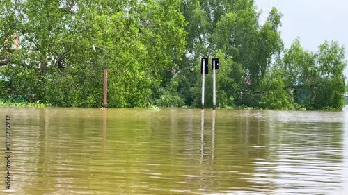 Rising water levels inundate roads and fields, showcasing the impact of recent heavy rainfall