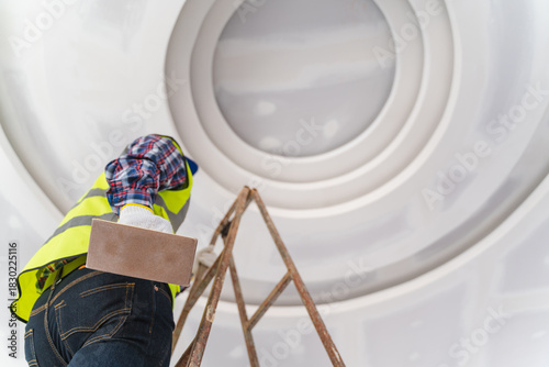 Construction Worker Applying Finishing Touches to Ceiling During Renovation Project with Focus on Detail and Precision in Modern Interior Space