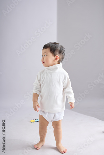 The child stands in a relaxed pose.