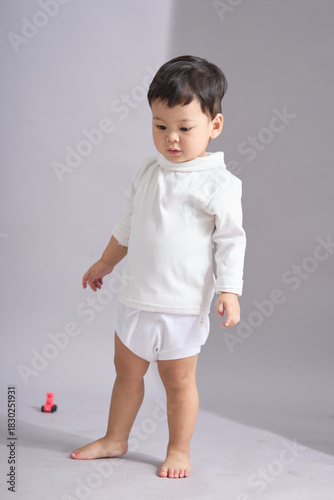 The child crouches down on the floor.