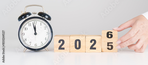 2025 end year to Happy New Year 2026 with vintage alarm clock. Christmas, New Start, Resolution, countdown, Goals, Plan, Action and Motivation Concept