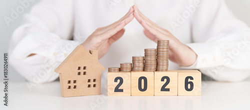 Happy New Year 2026 with hand cover money stack. Insurance, real estate, Home loan, tax, investment, mortgage, financial, savings, protection and safety