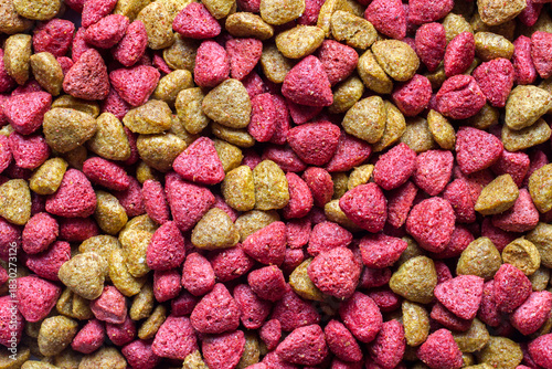 Combined vitaminized dry pet food. Yellow and pink dry food