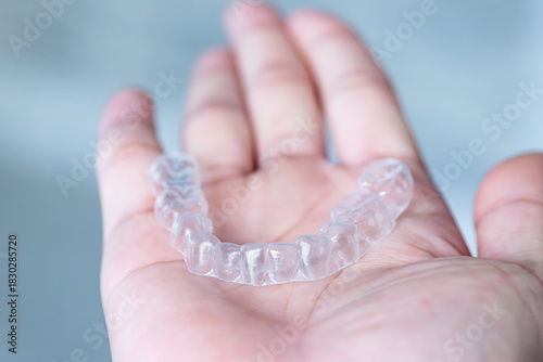  clear aligners device in the mouth on a white background. (invisalign)