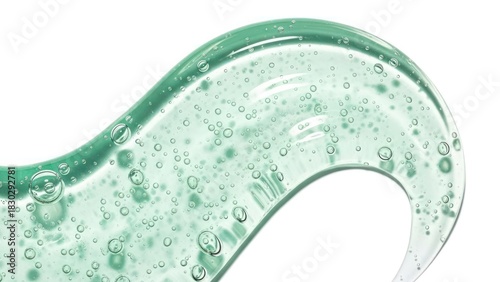 Close-up of a swirling, translucent gel with tiny bubbles, isolated.