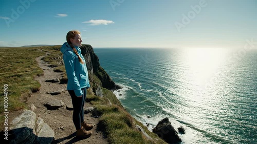 Woman Enjoying Coastal View - A Serene Moment of Reflection.