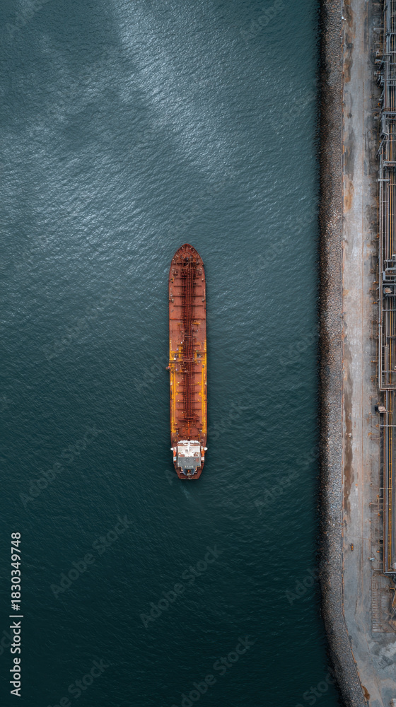 Fototapeta premium Aerial view oil tanker docking harbor industrial calm over deep blue water