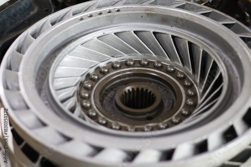 Schilderij op canvas Detailed metallic torque converter stator or impeller assembly with central splined hub and exposed ball bearings, symbolizing complex automotive engineering and precision transmission repair