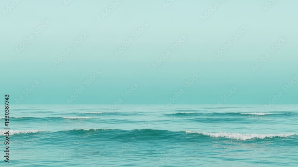 Obraz premium A serene ocean with gentle waves and a clear sky.