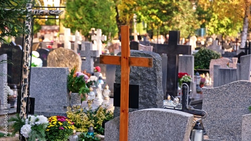 Traditional Wooden Burial Crucifix among Limestone Stone Tombstones Graves at Christian Catholic Cemetery