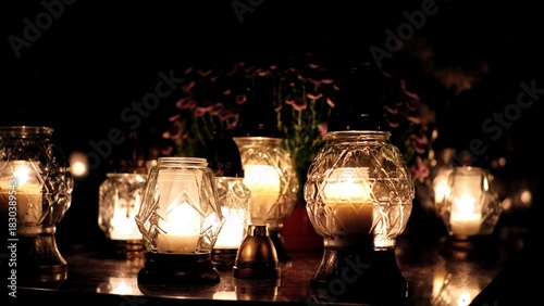 Votive Candle Lanterns on Surface of Limestone Grave Tombstone at All Saint Day Evening