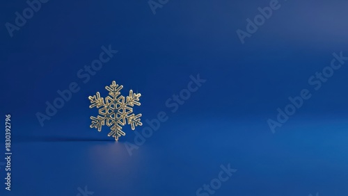 A single golden snowflake on a blue background.