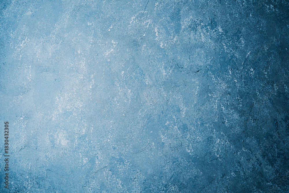 Obraz premium Grunge blue plaster wall with weathered texture and mottled pattern