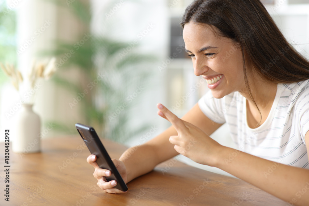 Fototapeta premium Happy woman waiting online result crossing fingers