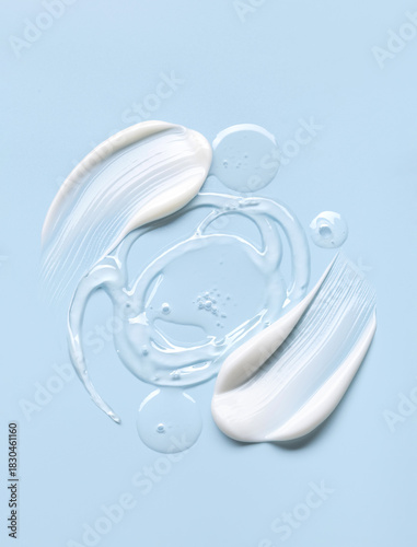 samples of cosmetic care products smear of cream and gel texture on a light blue background, moisturizing and skin care concept