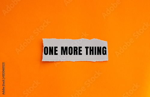 One More Thing message written on ripped torn paper background. Conceptual One More Thing symbol. Copy space.